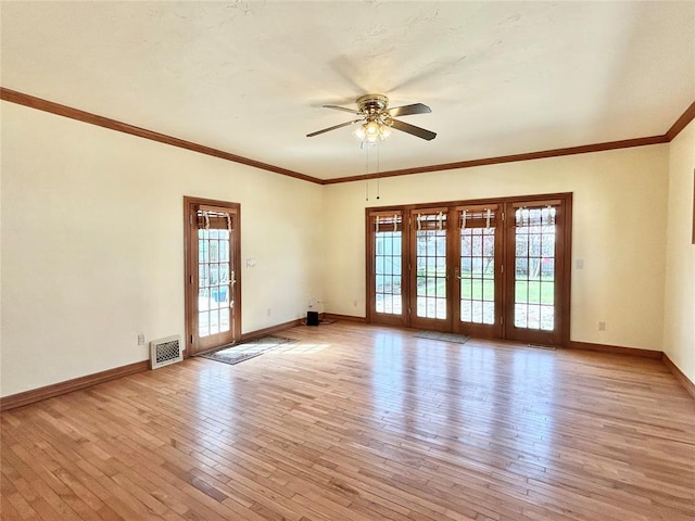 1909 N Gatewood Ave, Oklahoma City, OK 73106 - unfurnished room featuring visible vents, ceiling fan, light wood-type flooring, and a healthy amount of sunlight