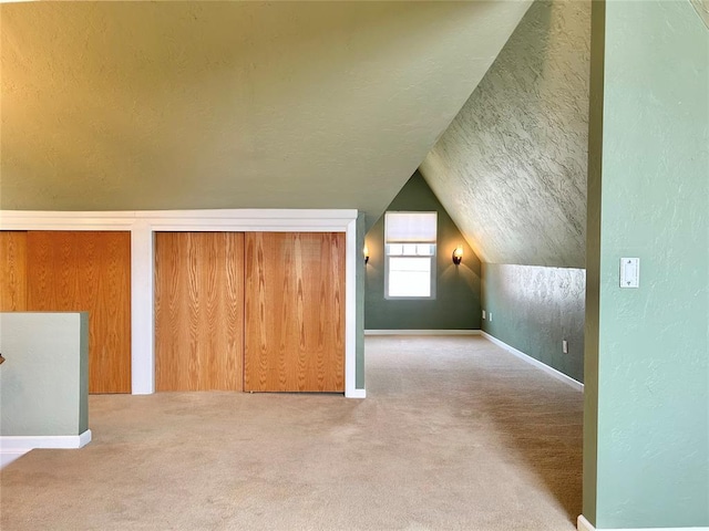1909 N Gatewood Ave, Oklahoma City, OK 73106 - bonus room featuring baseboards, carpet, a textured wall, a textured ceiling, and vaulted ceiling