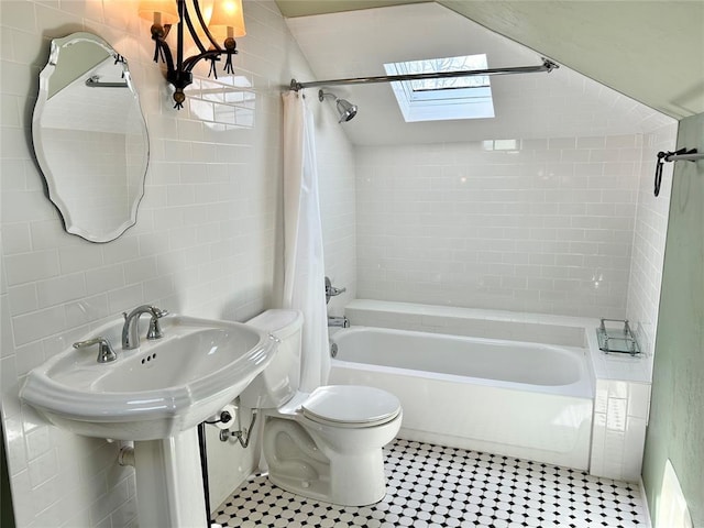 1909 N Gatewood Ave, Oklahoma City, OK 73106 - bathroom featuring shower / bath combo with shower curtain, tile walls, toilet, and a skylight