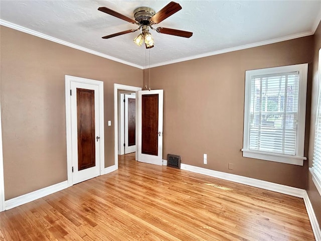 1909 N Gatewood Ave, Oklahoma City, OK 73106 - unfurnished room with baseboards, ornamental molding, a ceiling fan, visible vents, and light wood finished floors
