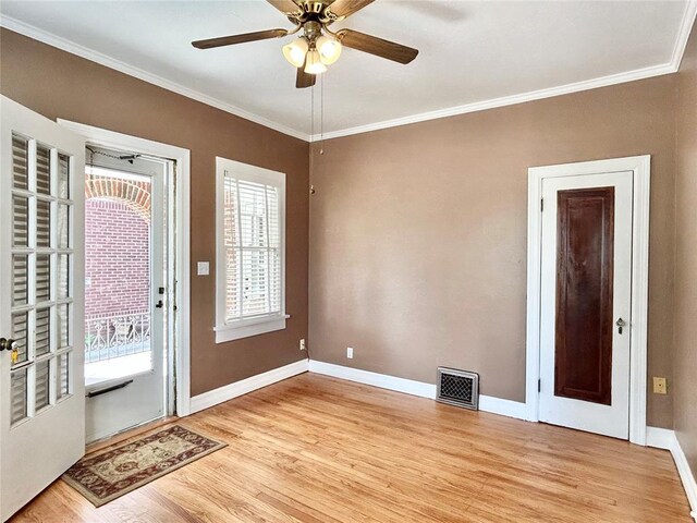 1909 N Gatewood Ave, Oklahoma City, OK 73106 - entryway featuring baseboards, crown molding, a ceiling fan, light wood-style floors, and visible vents
