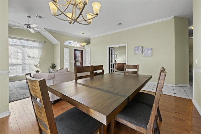 4113 Annalane Dr, Norman, OK 73072 - dining room featuring wood finished floors, ceiling fan with notable chandelier, and visible vents