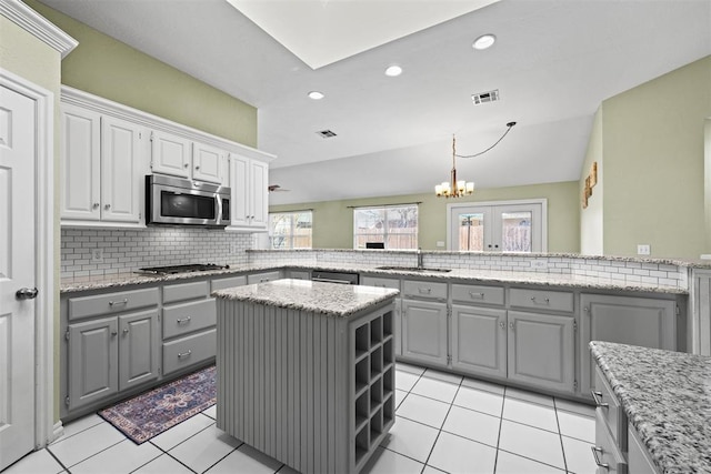 4113 Annalane Dr, Norman, OK 73072 - kitchen with gray cabinetry, backsplash, a sink, and stainless steel appliances