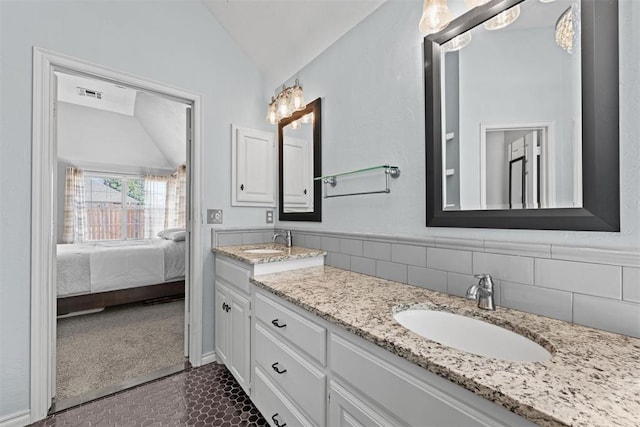 4113 Annalane Dr, Norman, OK 73072 - ensuite bathroom with double vanity, a sink, vaulted ceiling, and visible vents