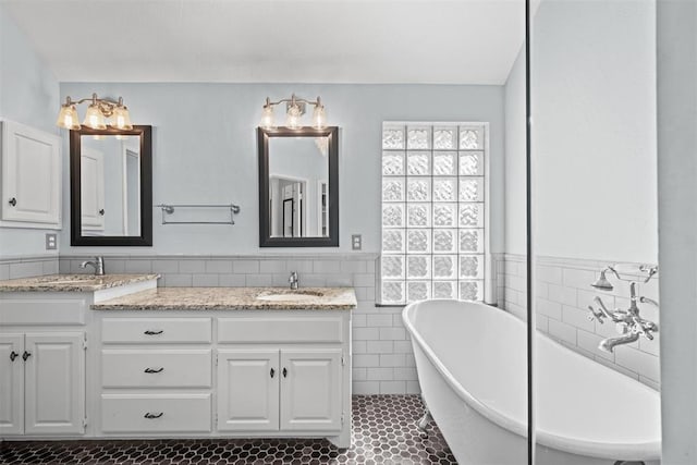 4113 Annalane Dr, Norman, OK 73072 - full bath featuring a sink, wainscoting, tile patterned flooring, a freestanding bath, and double vanity