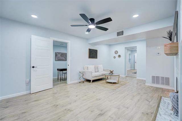 sitting room with wood finished floors, baseboards, ceiling fan, and visible vents