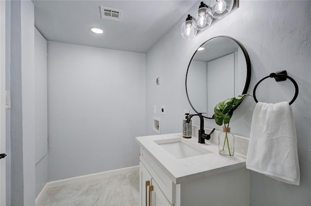 bathroom featuring baseboards, visible vents, and vanity