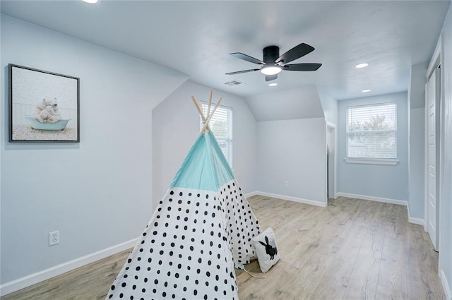 recreation room featuring wood finished floors, plenty of natural light, and visible vents