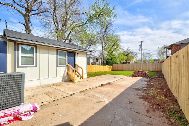 view of patio featuring cooling unit, entry steps, and fence private yard