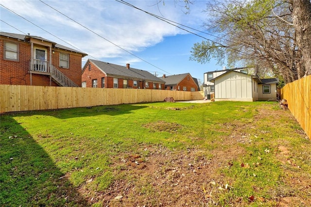 view of yard featuring an outbuilding and a fenced backyard