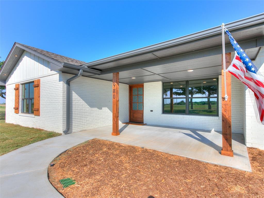 1642 County Road 1220, Tuttle, OK 73089 - view of front of property with brick siding and a patio area