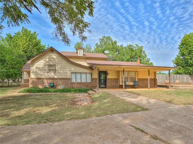 27704 S County Line Ave, Blanchard, OK 73010 - tri-level home featuring fence, brick siding, and a front yard