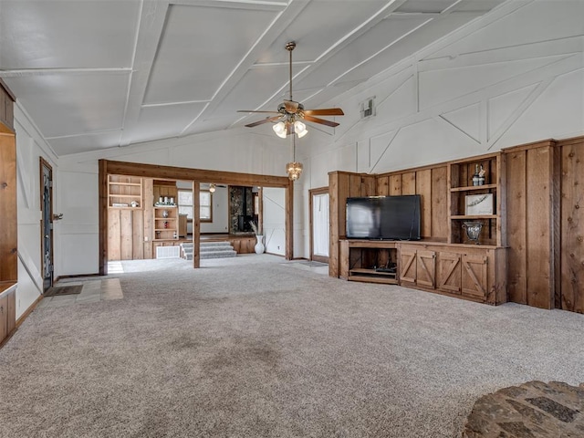 27704 S County Line Ave, Blanchard, OK 73010 - unfurnished living room with a ceiling fan, wood walls, carpet floors, and high vaulted ceiling