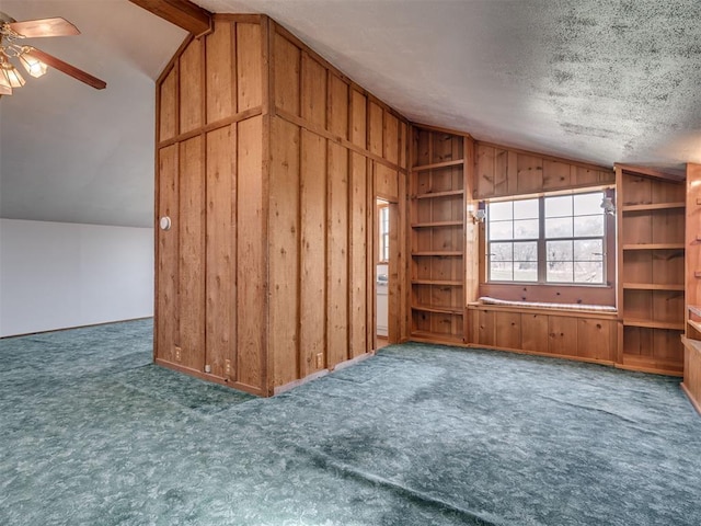 27704 S County Line Ave, Blanchard, OK 73010 - additional living space featuring wooden walls, vaulted ceiling, carpet floors, a textured ceiling, and ceiling fan