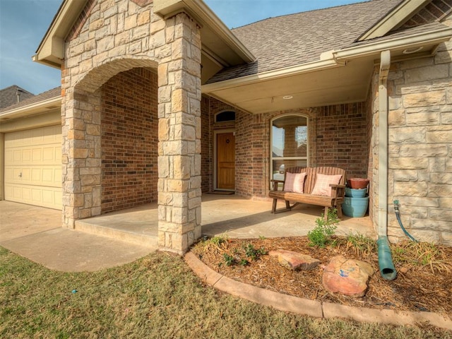 904 Majestic St, Yukon, OK 73099 - entrance to property with roof with shingles, brick siding, a garage, and stone siding
