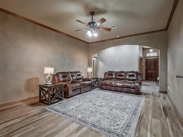904 Majestic St, Yukon, OK 73099 - living area featuring arched walkways, wood finished floors, ceiling fan, crown molding, and baseboards