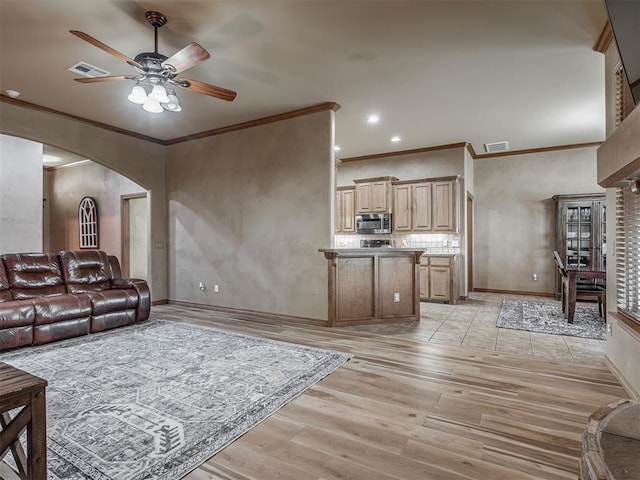 904 Majestic St, Yukon, OK 73099 - living room featuring ceiling fan, arched walkways, light wood-style flooring, ornamental molding, and baseboards