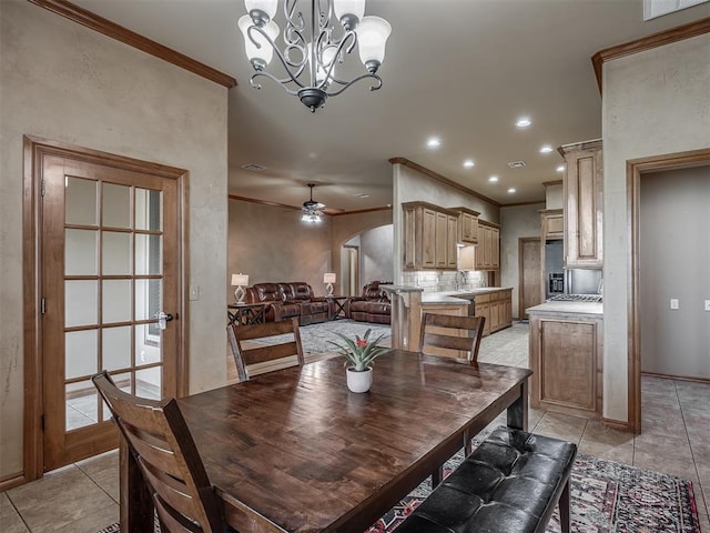 904 Majestic St, Yukon, OK 73099 - dining space featuring ornamental molding, a chandelier, light tile patterned floors, ceiling fan, and arched walkways