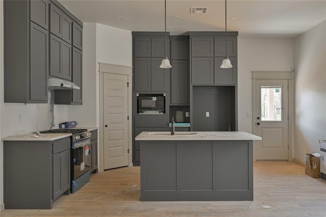 128 E 7th St, Arcadia, OK 73007 - kitchen featuring gray cabinets, under cabinet range hood, visible vents, stainless steel gas stove, and a sink
