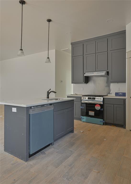 128 E 7th St, Arcadia, OK 73007 - kitchen with gray cabinets, dishwasher, under cabinet range hood, light wood finished floors, and stainless steel gas stove