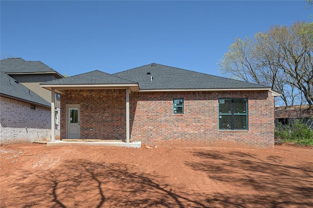 128 E 7th St, Arcadia, OK 73007 - rear view of house with brick siding and a shingled roof