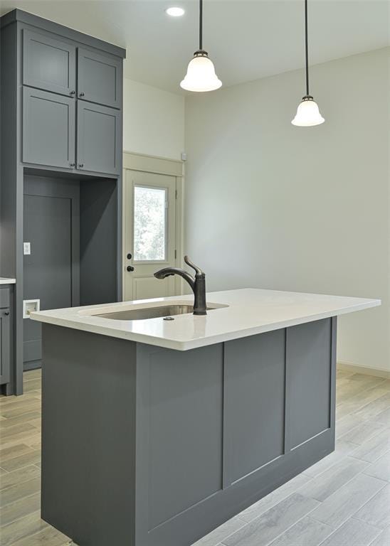 128 E 7th St, Arcadia, OK 73007 - kitchen with gray cabinetry, a sink, light wood-style flooring, light countertops, and recessed lighting