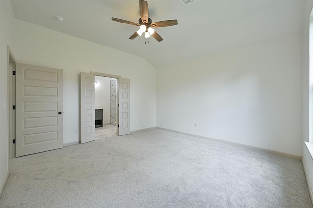 128 E 7th St, Arcadia, OK 73007 - unfurnished bedroom featuring light carpet, lofted ceiling, baseboards, and ensuite bath