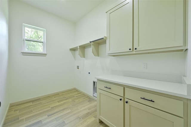 128 E 7th St, Arcadia, OK 73007 - washroom with electric dryer hookup, light wood-style flooring, hookup for a washing machine, cabinet space, and baseboards