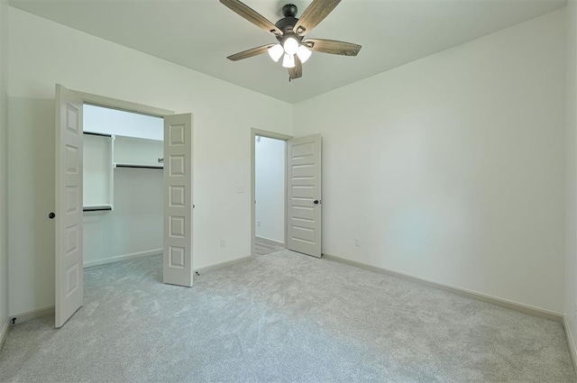 128 E 7th St, Arcadia, OK 73007 - unfurnished bedroom featuring light carpet, baseboards, a closet, ceiling fan, and a spacious closet