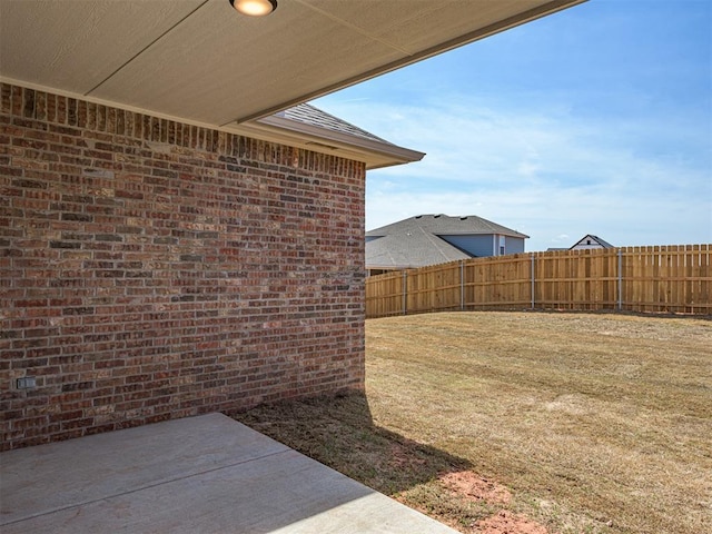 view of yard featuring fence and a patio