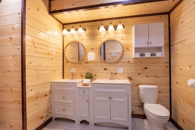 167 Penner Rd, Broken Bow, OK 74728 - full bathroom featuring double vanity, a sink, toilet, and wood walls