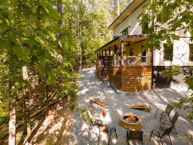 167 Penner Rd, Broken Bow, OK 74728 - view of side of home with a fire pit, stairs, and a patio area