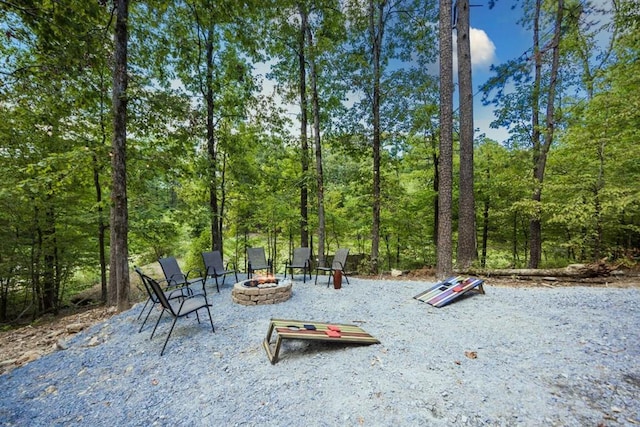 167 Penner Rd, Broken Bow, OK 74728 - exterior space featuring an outdoor fire pit and a wooded view