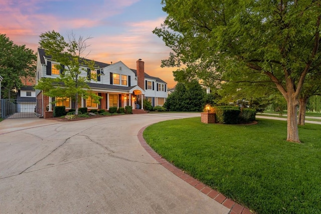 1707 Pennington Way, Nichols Hills, OK 73116 - view of front of property with curved driveway, a gate, a porch, and a chimney