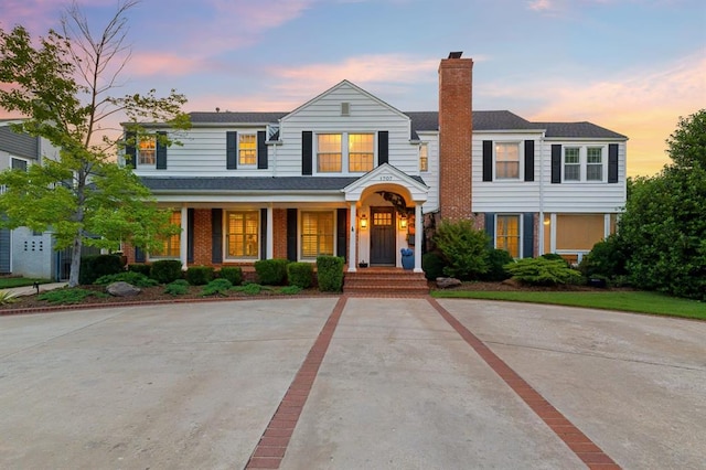 1707 Pennington Way, Nichols Hills, OK 73116 - view of front of house featuring a chimney and a porch