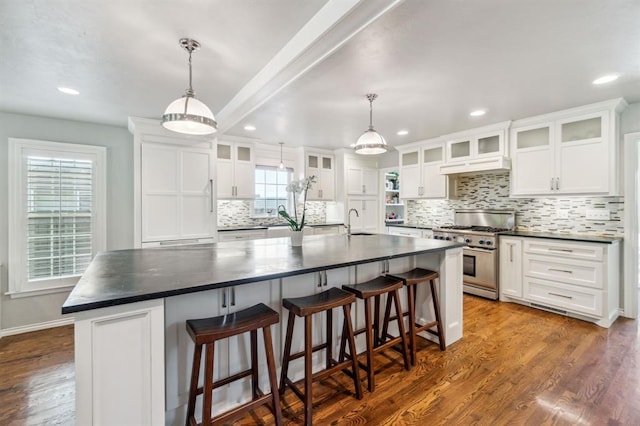1707 Pennington Way, Nichols Hills, OK 73116 - kitchen with high end stainless steel range oven, dark countertops, a sink, tasteful backsplash, and recessed lighting