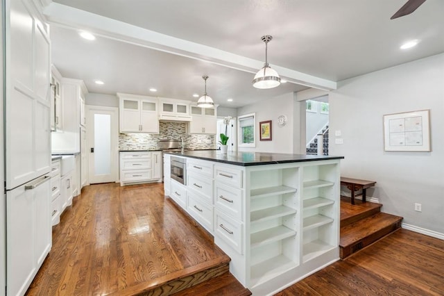 1707 Pennington Way, Nichols Hills, OK 73116 - kitchen with dark countertops, stainless steel microwave, white cabinets, dark wood-type flooring, and recessed lighting