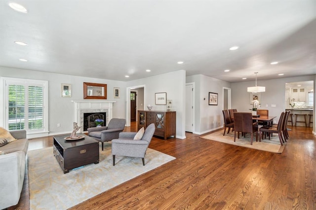 1707 Pennington Way, Nichols Hills, OK 73116 - living room with recessed lighting, wood finished floors, a high end fireplace, and baseboards
