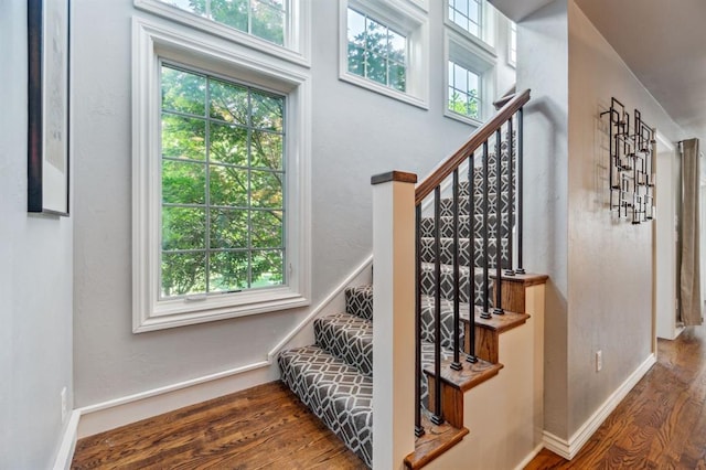 1707 Pennington Way, Nichols Hills, OK 73116 - staircase featuring plenty of natural light, wood finished floors, and baseboards