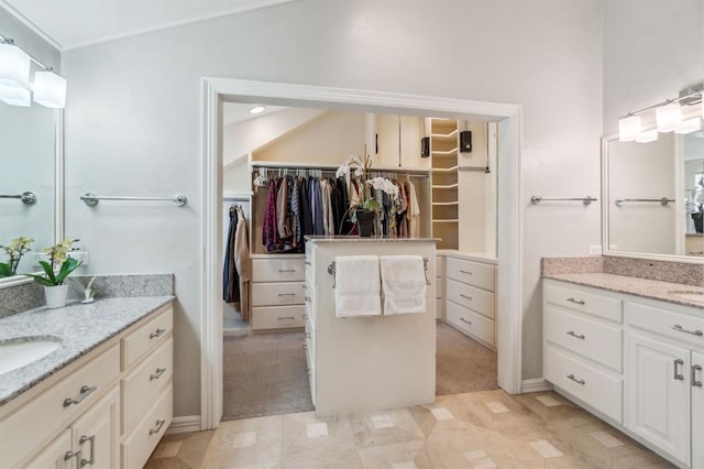 1707 Pennington Way, Nichols Hills, OK 73116 - bathroom featuring two vanities, a walk in closet, and tile patterned floors