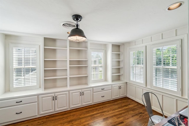 1707 Pennington Way, Nichols Hills, OK 73116 - unfurnished office featuring dark wood-style flooring, plenty of natural light, and built in shelves