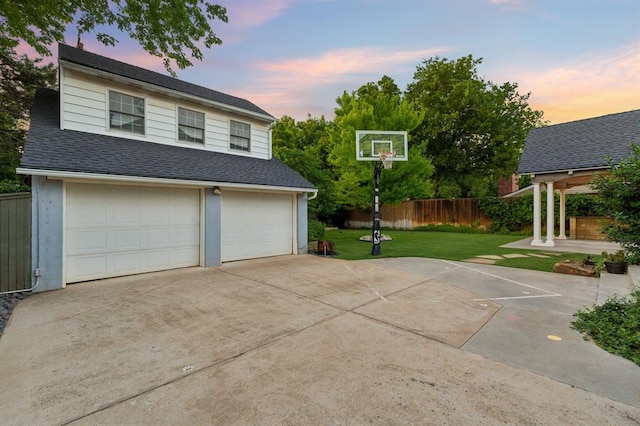 1707 Pennington Way, Nichols Hills, OK 73116 - garage at dusk featuring concrete driveway