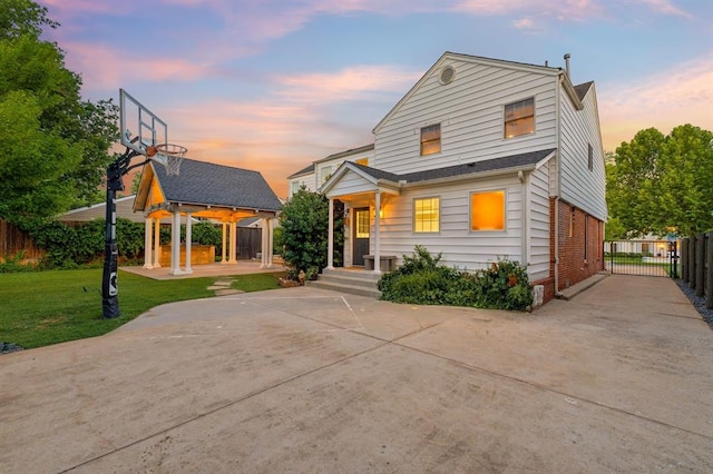 1707 Pennington Way, Nichols Hills, OK 73116 - view of front of home with driveway, brick siding, a gazebo, and a gate