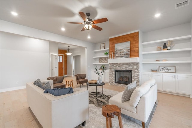 living room with a fireplace, light wood-style flooring, visible vents, ceiling fan, and recessed lighting