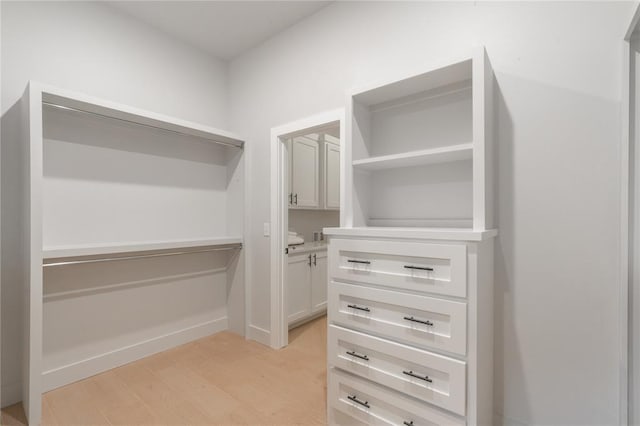 spacious closet with light wood-style floors