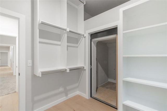 spacious closet with wood finished floors