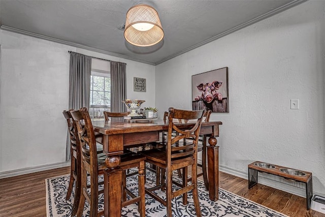 2837 Cambridge Ct, Oklahoma City, OK 73116 - dining space with a textured wall, wood finished floors, and ornamental molding
