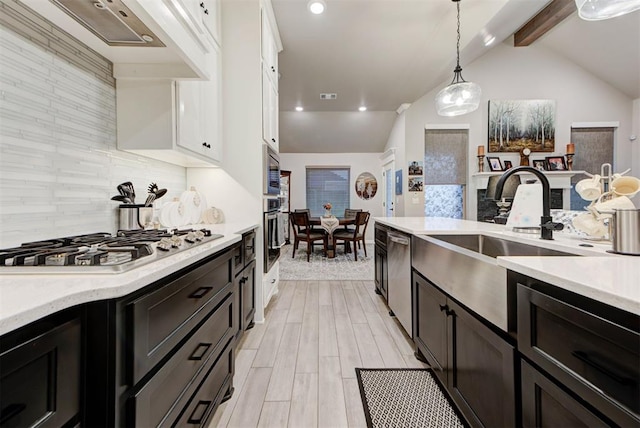5513 Carmel Creek Dr, Mustang, OK 73064 - kitchen featuring stainless steel appliances, white cabinets, a sink, pendant lighting, and premium range hood