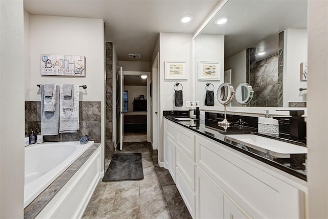5513 Carmel Creek Dr, Mustang, OK 73064 - ensuite bathroom featuring double vanity and a bath