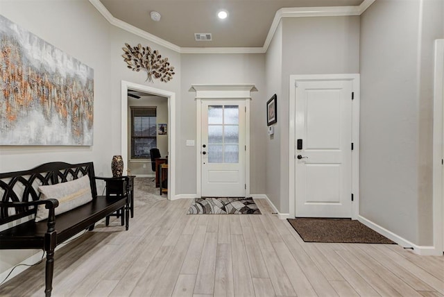 5513 Carmel Creek Dr, Mustang, OK 73064 - foyer with light wood-style flooring, crown molding, and baseboards